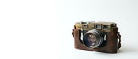Vintage film camera with leather body and metal accents on clean white background, retro photography equipment for nostalgic design projects.