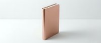 Closed rose gold notebook or journal isolated on white background, suitable for stationery, office, and design mockups.