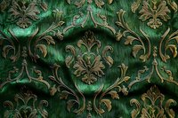 Luxurious emerald green damask pattern with ornate gold baroque flourishes and scrollwork creates rich vintage textile design for elegant home decor and wallpaper.