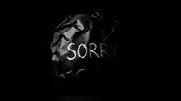 Crumpled black paper ball with the word Sorry written in white on dark background, symbolizing regret, apology, and emotional conflict.
