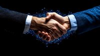 Business handshake with glowing blue digital network effect on black background, symbolizing technology partnership and digital transformation success.