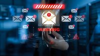 Cybersecurity threat alert with warning envelope and email icons on digital interface. Business hand pointing at security breach notification system.