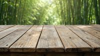 Wooden deck table surface with blurred bamboo forest background, suitable for product display and nature-themed designs.