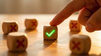 Hand selecting wooden cube with green checkmark among blocks with red X marks representing choice, decision making, and quality selection process.