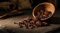 Star anise and cloves spilling from a rustic wooden bowl on a dark stone surface, warm moody tones, aromatic spices for cooking and food styling.