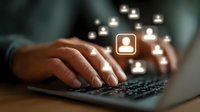 Professional hands typing on laptop keyboard with glowing user profile icons floating above, representing digital networking and online communication.