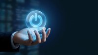 Hand holding glowing blue power button icon against dark digital background. Technology, energy, startup, and control concept for business presentations.