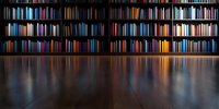 Dark wooden floor reflecting colorful bookshelves filled with books in library interior, dramatic lighting creates mysterious atmosphere for educational concepts.