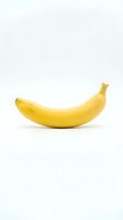 Single ripe yellow banana isolated on white background, ready for design use on packaging, advertising, and nutritional content.