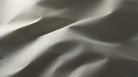 Smooth fabric texture with soft folds and gentle shadows, suitable for backgrounds, textile design, and material mockups.