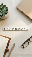 Framework spelled in wooden letter tiles on white desk with succulent plant, notebook, pen and glasses for business planning and strategy development.