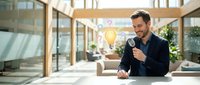 Professional businessman having video call in modern office space with natural lighting and contemporary architecture.