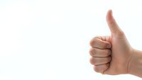 Human hand showing thumbs up gesture on white background expressing approval, success and positive feedback for business presentations.
