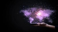 Glowing purple world map constellation floating above open palm against dark background, stars and nebula effects create magical atmosphere.