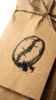 Rustic kraft paper gift package tied with natural twine featuring hand-drawn tomato illustration stamp for organic farm branding and artisan food packaging.