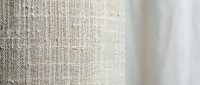 Natural beige linen fabric texture with woven fibers and soft white curtain background for interior design and textile applications.