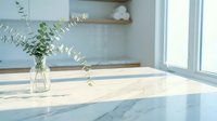 Modern kitchen interior with marble countertop, eucalyptus branches in glass vase, natural light from window creating minimalist home design atmosphere.