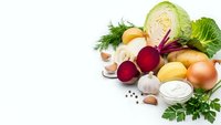 Fresh organic vegetables and herbs arranged on white background with copy space for healthy cooking and nutrition concepts.