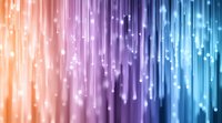 Vibrant gradient background with glowing light streaks and bokeh effects transitioning from warm orange to cool blue tones for digital design projects.