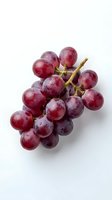 Fresh red grapes cluster with water droplets isolated on white background for healthy eating and nutrition concepts.