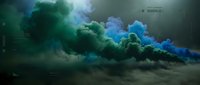 Dramatic colored smoke clouds in vibrant green and blue hues billowing across dark surface creating atmospheric special effects for creative projects.