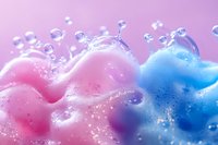 Vibrant pink and blue liquid waves with floating water drops creating dynamic splash effect against light background, macro photography for cosmetic advertising.