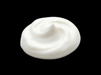 Swirled white cream dollop isolated on transparent background, ready for food, cosmetic, and beauty design use in clipart, stickers, and print on demand projects.