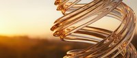 Copper wire coils spiral against warm sunset backdrop creating industrial abstract composition for technology and manufacturing concepts.