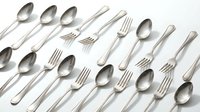 Assorted silver stainless steel forks and spoons arranged in a flat lay pattern on a white background, showcasing elegant cutlery set.