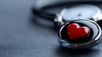 Red heart shape inside vintage pocket watch on dark textured background, romantic time concept for valentines day and anniversary celebrations.
