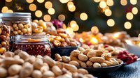 Festive holiday snacks with nuts, cranberries in glass jars on wooden table against blurred golden bokeh lights creating cozy atmosphere for winter celebration.