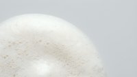 White foam bubbles texture close-up with soft lighting on neutral background for skincare cosmetics and spa wellness design concepts.