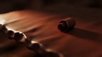 Scattered ammunition cartridges with selective focus on a single red shell casing, illuminated by warm dramatic lighting against a dark surface for forensic or crime scene concepts.