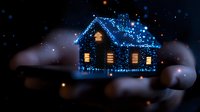 Magical winter house silhouette glowing with blue Christmas lights against dark night sky, illuminated windows creating cozy atmosphere amid falling snow.