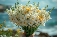 Fresh bouquet of white narcissus and yellow daffodils held against blurred ocean background, spring flowers in natural sunlight creating romantic mood.