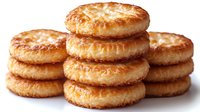 Golden flaky pastry rings stacked in appetizing piles on white background, isolated bakery goods ready for culinary design and food marketing materials.