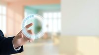 Businessman hand holding futuristic digital circle interface with arrow symbol in modern office environment for technology and innovation concepts.