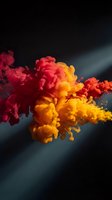 Vibrant colored ink clouds dispersing in water creating abstract fluid motion with red yellow orange hues against dark background for creative design.