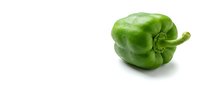 Fresh green bell pepper isolated on white background, ready for culinary, food packaging, and recipe design projects.