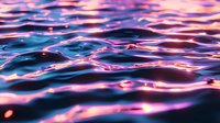 Mesmerizing water surface with vibrant pink and purple light reflections creating dynamic ripples and waves against deep blue tones at sunset.