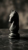Metallic chess knight piece isolated on dark marble surface with soft bokeh background, suitable for strategy, game, and business concept designs.