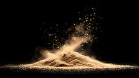 Explosive cloud of golden powder or flour dust against black background creates dramatic effect with particles floating in air and light illumination.