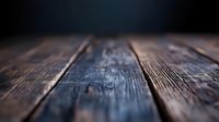 Rustic wooden planks with natural grain texture and shallow depth of field creating atmospheric background for product photography and design layouts.