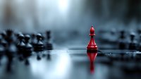 Red chess piece standing alone on reflective surface with blurred dark pieces in background, dramatic lighting creates mysterious atmosphere.