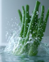 Fresh green asparagus spears splashing in clear water with dynamic water drops and motion captured movement against light background, macro photography.
