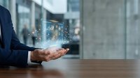 Businessman hands presenting holographic digital technology interface with glowing particles in modern office environment for innovation concepts.