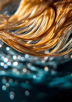 Flowing golden hair strands with soft bokeh lights against dark turquoise background, creating dreamy atmosphere with selective focus and macro photography style.