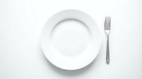 Empty white plate with fork on white background, isolated tableware setup for dining, restaurant, and food service design projects.