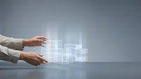 Professional hands manipulating holographic digital cube structure with glowing wireframe grid pattern for technology and innovation concepts.