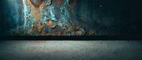 Industrial concrete floor meets weathered metal wall with rust and peeling paint creating dramatic texture contrast for urban design projects.
